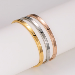 Three-piece stainless steel butterfly bangle set in gold, silver, and rose gold finishes