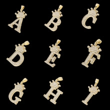 Macro shot of 18K gold-plated alphabet pendants A-I with sparkling crown detail set