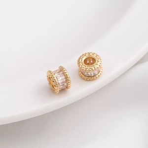 Macro detail of 14K gold filled wheel spacers with micro-pave cubic zirconia inlay