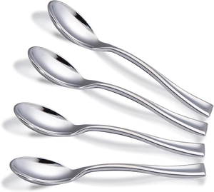 Close-up of four mini silver electroplated disposable spoons on white background