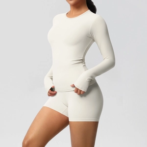 Detail of cream yoga set showing long sleeve top with thumbholes and high waist shorts