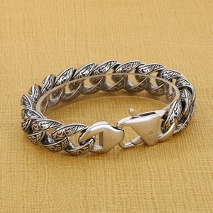 Close-up of retro 18mm stainless steel link bracelet with engraved floral patterns