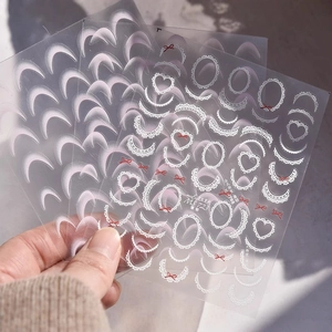 Lace French nail art stickers with heart patterns and bows on a thin flexible film