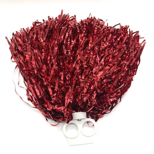 Close-up of vibrant red metallic foil cheerleading pom pom with white plastic handle