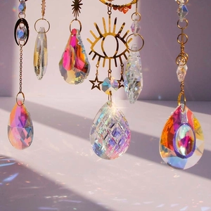 Golden celestial suncatcher with crystals and stars creating rainbow light reflections