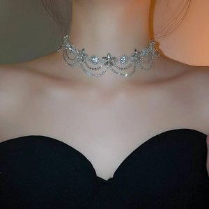 Detailed view of silver flower choker necklace with sparkling rhinestones and delicate tassels