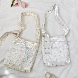 Detail of floral velvet shoulder bags with lace embroidery and cute bear patterns