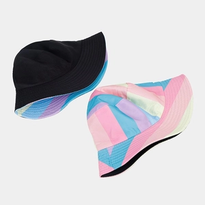 Detail of reversible rainbow bucket hat showing black and colorful striped dual-side design