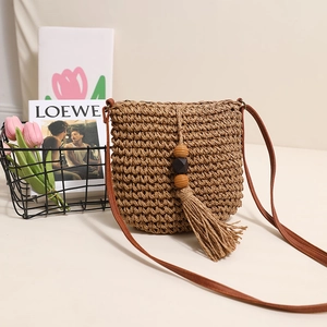 Brown straw crossbody bag with long tassels and wood beads for seaside beach vacation