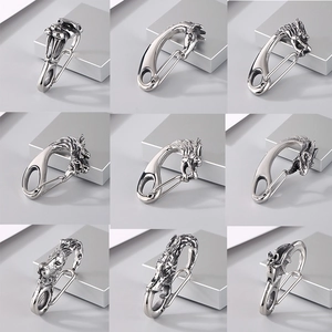 Macro view of vintage stainless steel animal head carabiner keychains with detailed carving