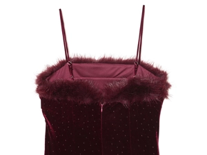 Detail of burgundy velvet midi dress with faux fur trim, sequins and invisible zipper
