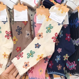 Knitted crew socks with floral embroidery in beige, pink, and navy cotton fabric