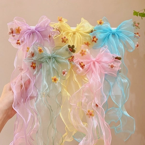 Rainbow lace bow hair clips for girls with floral details in colorful pastel shades