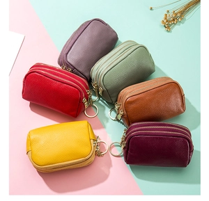 Detailed view of multi-color litchi grain leather mini purses with three zippers and keychains