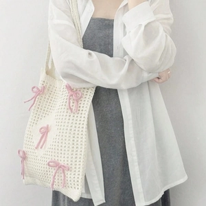 Minimalist cream knit shoulder bag with pink bow pattern and hollow texture for women