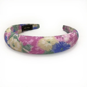 Detail of bohemian floral padded headband with pink and purple flower pattern fabric