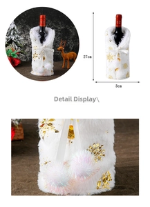 Detailed view of white plush Christmas wine bottle cover with golden snowflake patterns