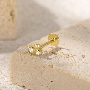 Detail of S925 silver ear stud with gold flower cluster and clear zircon stones