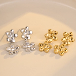 Minimalist stainless steel flower tassel earrings in polished gold and silver finishes