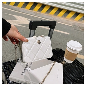 Close-up of a white quilted PVC jelly bag with gold chain and floral clasp detail