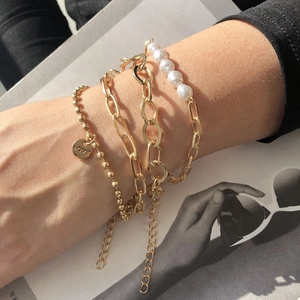 Layered gold pearl bracelet set with Love coin pendant for fashion jewelry style