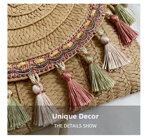 Detail of bohemian woven straw bag featuring colorful tassels and embroidered wavy ribbon