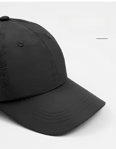 Close-up of wide-brimmed black baseball cap with premium nylon stitching and breathable vents