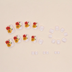 Floral press-on toenails with vibrant orange and yellow flowers on glossy white base