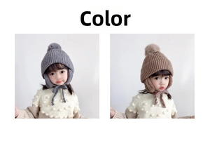 Detail of knit kids winter hat with earflaps, pom pom and chin straps in grey and coffee