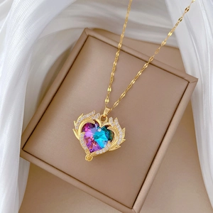 Luxurious titanium heart pendant necklace with colorful crystal and wings on white silk