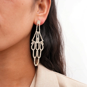 Detailed view of long fan-shaped tassel earrings with pavé rhinestones on model