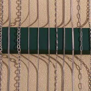 Various stainless steel chain styles including snake, link, and rope designs on display