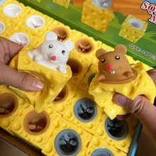 Close-up of hand squeezing yellow cheese toy with mice popping out for stress relief