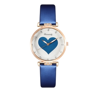 Detail of rose gold watch dial featuring a blue heart pattern and rhinestone markers