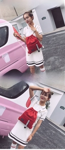 Detail of red drawstring canvas backpack with thick cotton rope and fashion letter ribbon