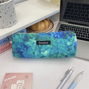 Close-up of vintage floral corduroy pencil case with zipper on a wooden study desk