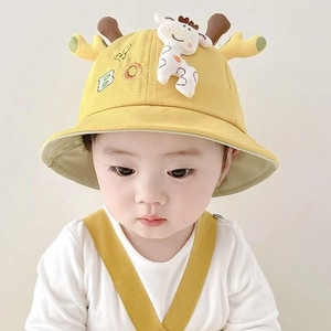 Close-up of yellow baby bucket hat with 3D giraffe ears and BOY embroidery detail