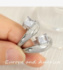 Detail shot of irregular silver ring with two square-cut cubic zirconia crystals