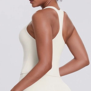 Close-up of racerback design on cream-colored yoga sports vest with smooth fabric