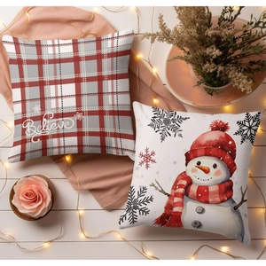 Christmas snowman and red plaid pillow covers set on a cozy decorative wooden surface