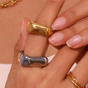 Close-up of stacked vintage minimalist rings in 18K gold and silver polished finish