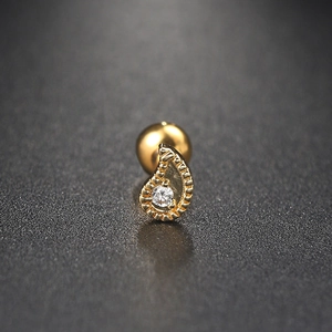 Macro detail of gold teardrop earring with cubic zirconia and screw ball back