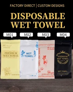 Four premium disposable wet towel packets in diverse elegant patterns on dark wood background