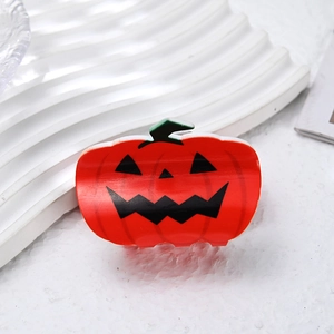 Cute Halloween pumpkin hair clip with classic orange finish and black spooky face design
