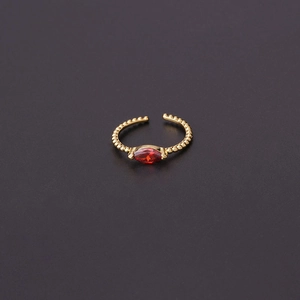 Close-up of golden beaded ring band with center red marquise-cut zircon gemstone