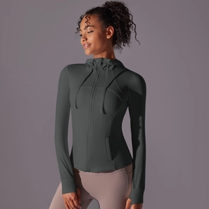 Detail of dark gray workout jacket showing thumb holes and slim fit hoodie zipper