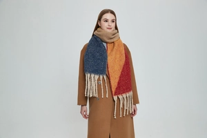 Detail of thick chunky tassel fringe on multi-color knit faux mohair scarf for winter