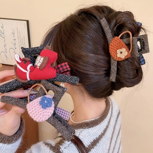 Detail of Korean-style knit bow claw clips featuring handmade fabric pony and mini bag charms
