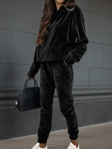 Detail of premium black velvet tracksuit with hooded sweatshirt and elastic cuffs