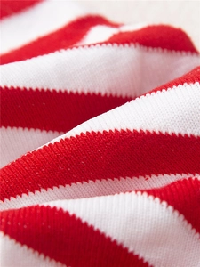 Macro shot of red and white striped knit texture on Christmas cotton socks for kids